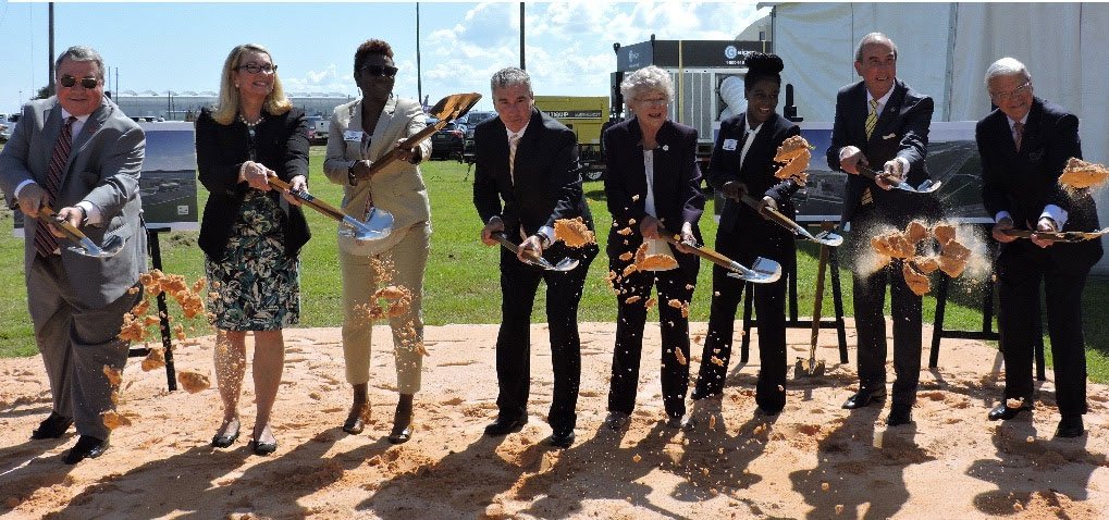 government officials holding shovels at airbus groundbreaking
