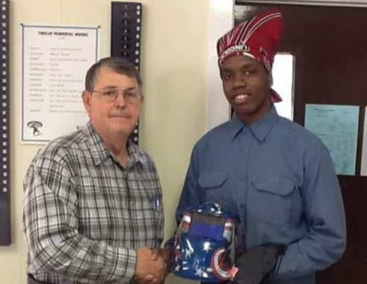 instructor and student shaking hands